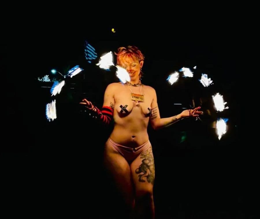 Bunny spinning lit fire fans in the dark, the flames blurred into wings around her.
